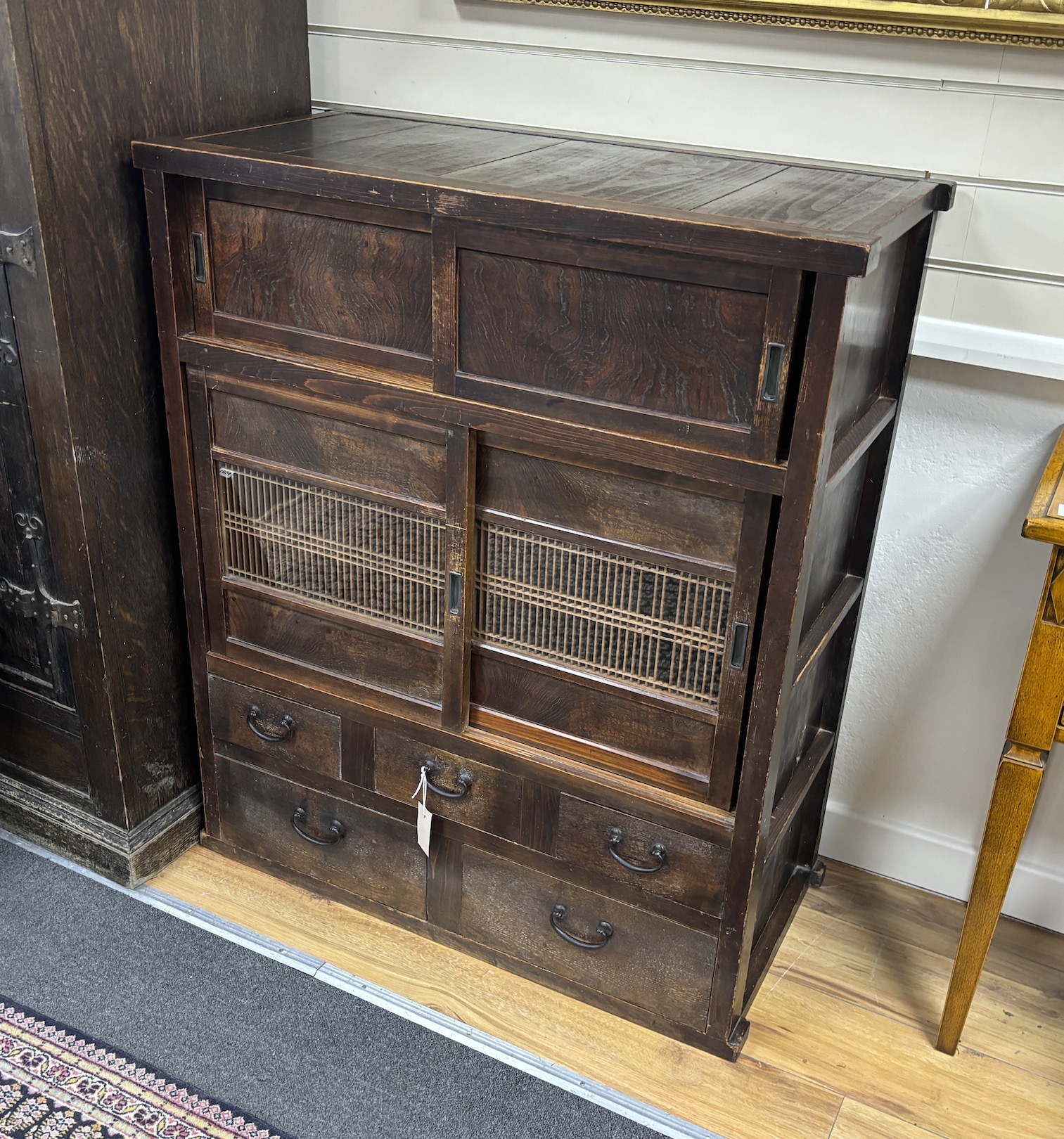 A Japanese hardwood cabinet, fitted with drawers and sliding panels, width 88cm, depth 42cm, height 104cm